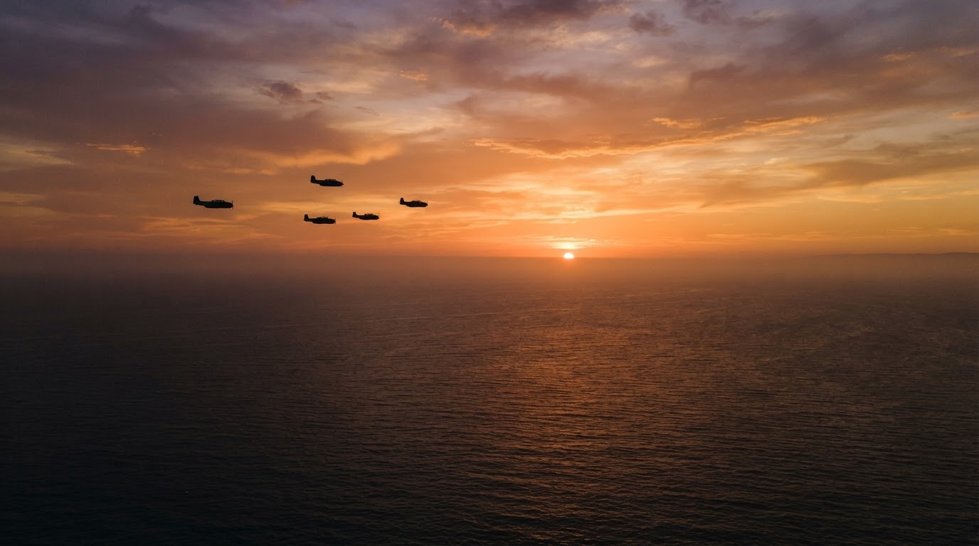 Five 1940s propeller torpedo bombers flying in formation as distant silhouettes over a sea lit by sunset (AI-generated image)
