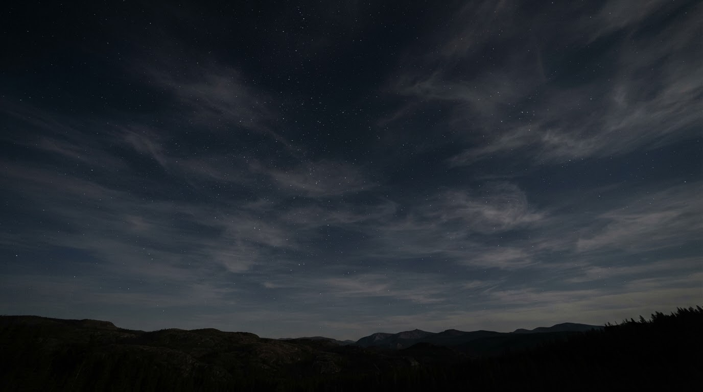 Thin stratospheric clouds spread across a night sky with stars scattered between them, no light from the ground (AI-generated image)