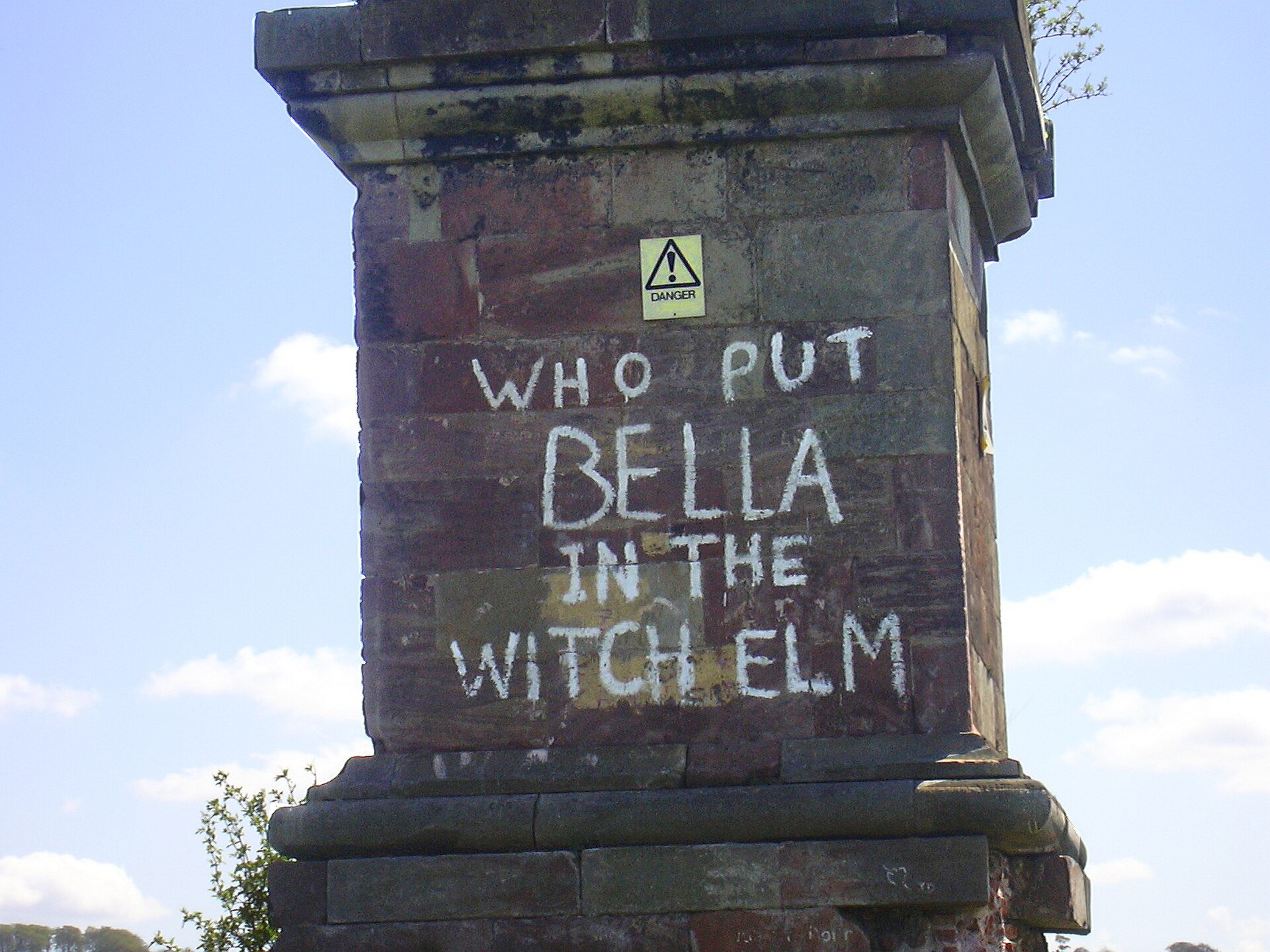 The actual graffiti on the base of the obelisk at Wychbury Hill, Worcestershire — "WHO PUT BELLA IN THE WITCH ELM".