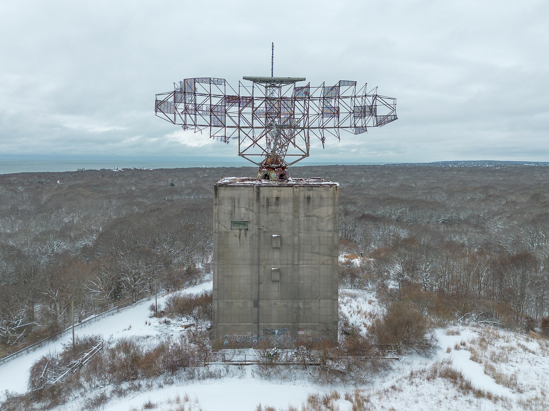 The AN/FPS-35 radar dish still standing at Camp Hero State Park — the birthplace of the Montauk legend, seen in snow-covered winter