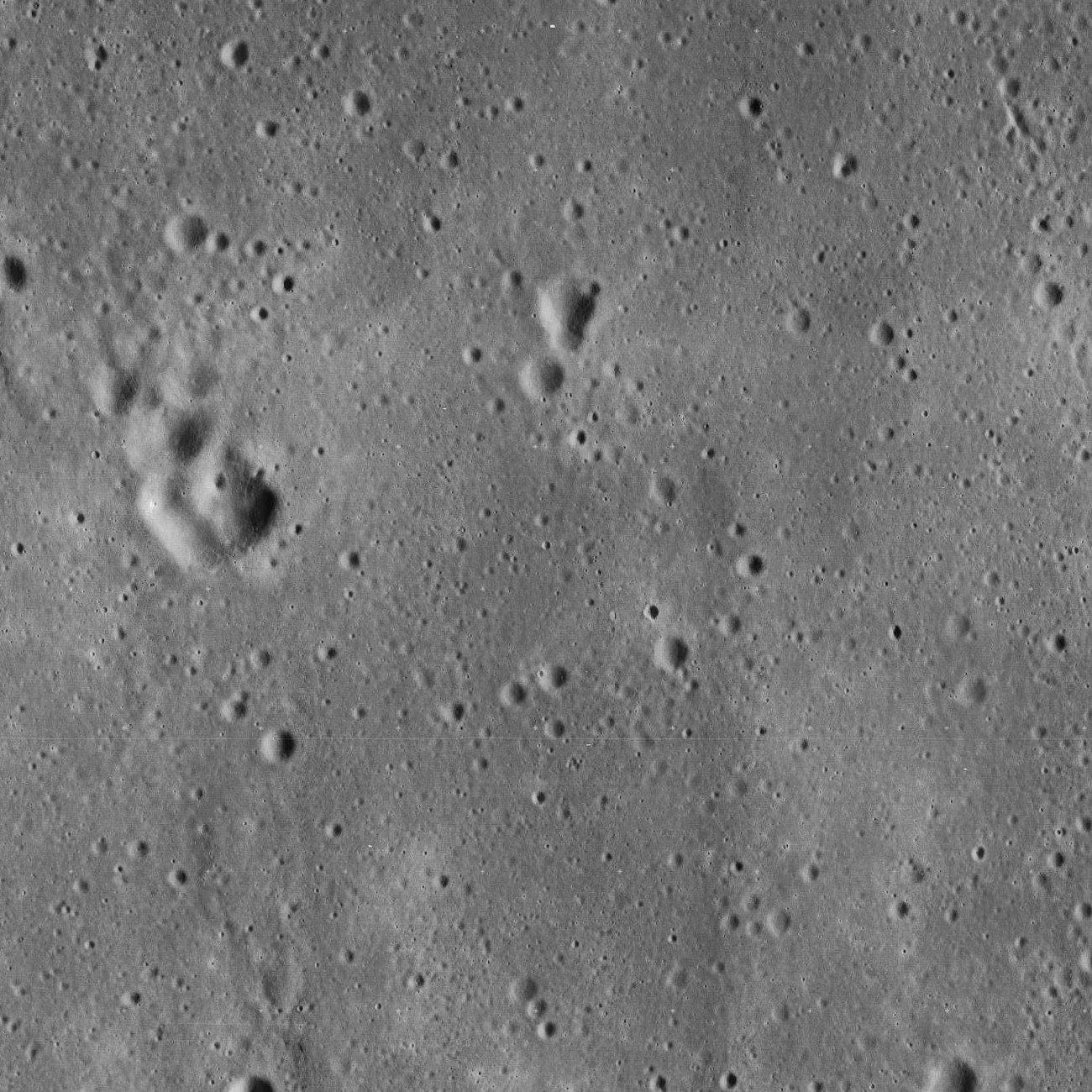 NASA's Lunar Reconnaissance Orbiter image of the Apollo 11 landing site — the descent stage casts a small, clear shadow on the surface below. (James Stuby based on NASA image / CC0)