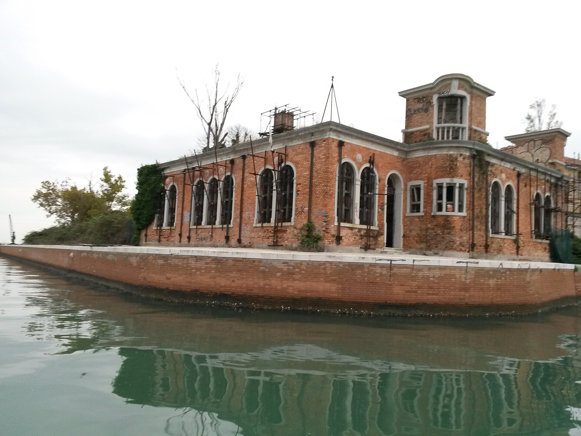 The ruins of Poveglia as they actually are — collapsed roofs and weed-covered remains of the buildings