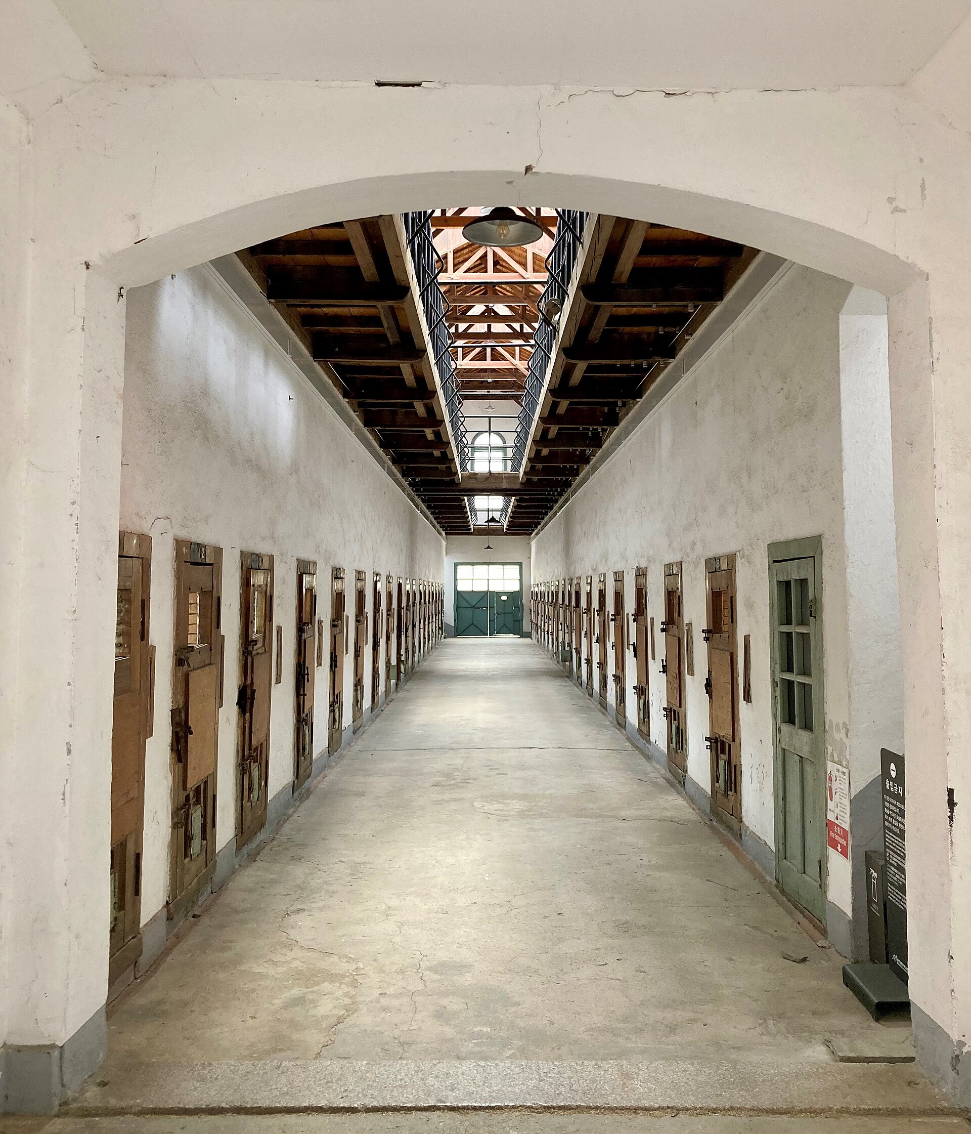 The interior corridor of a cell block at the former Seodaemun Prison, cell doors lining both sides — not Busan Prison, but a real Korean prison interior shown as a stand-in