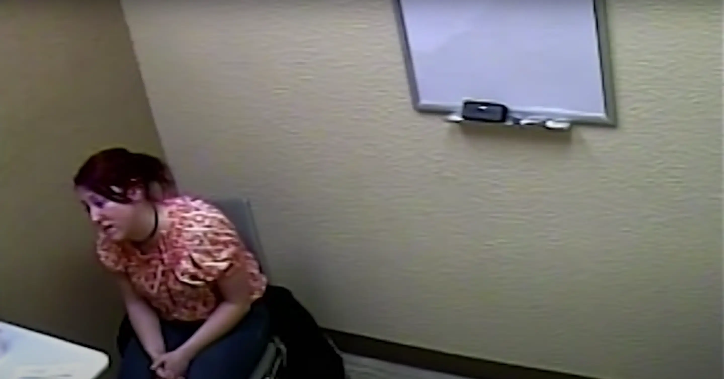 A woman seated in a police interrogation room — and still, she denied it.