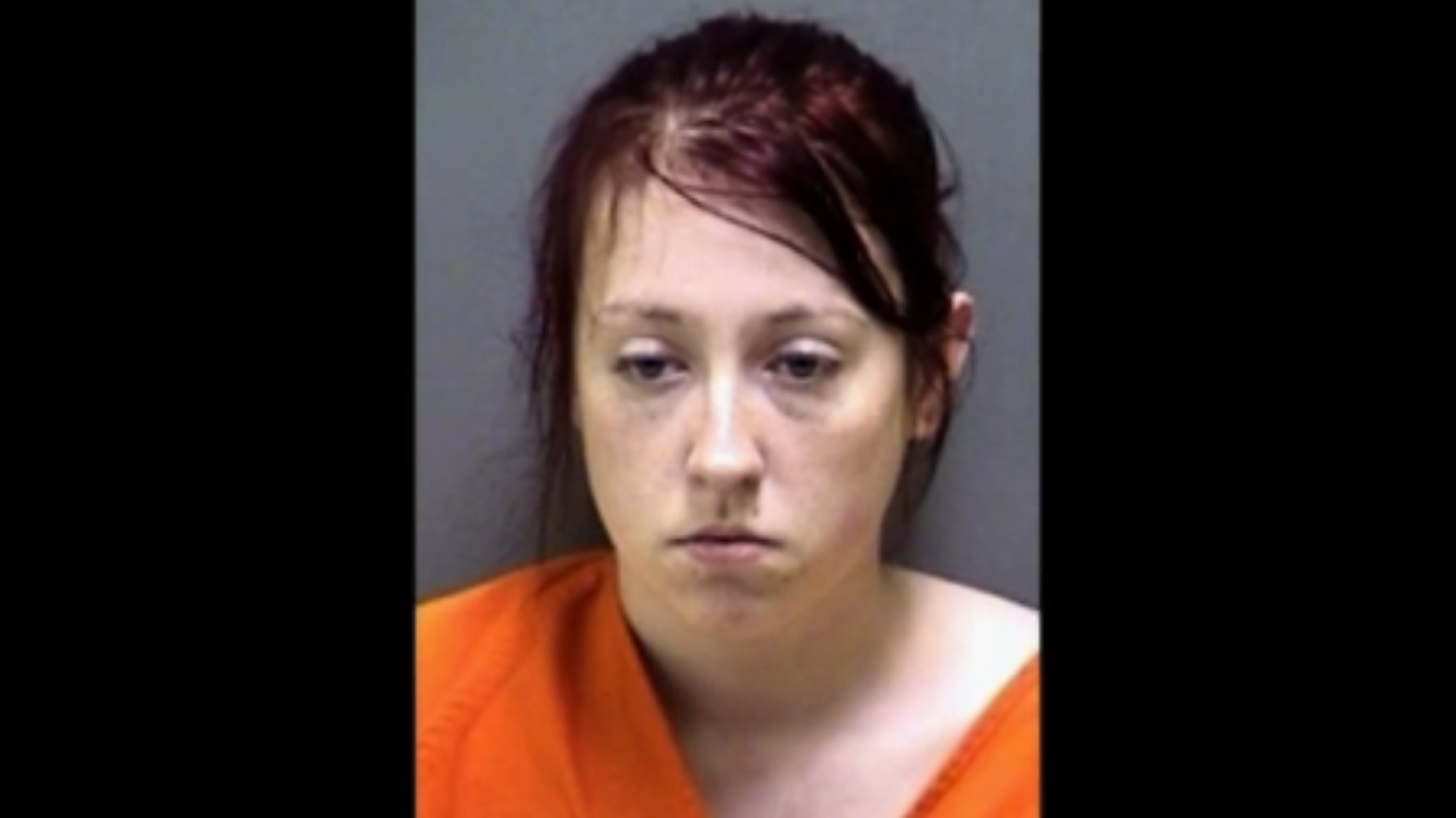 A jailhouse photo of the woman in an orange jumpsuit.